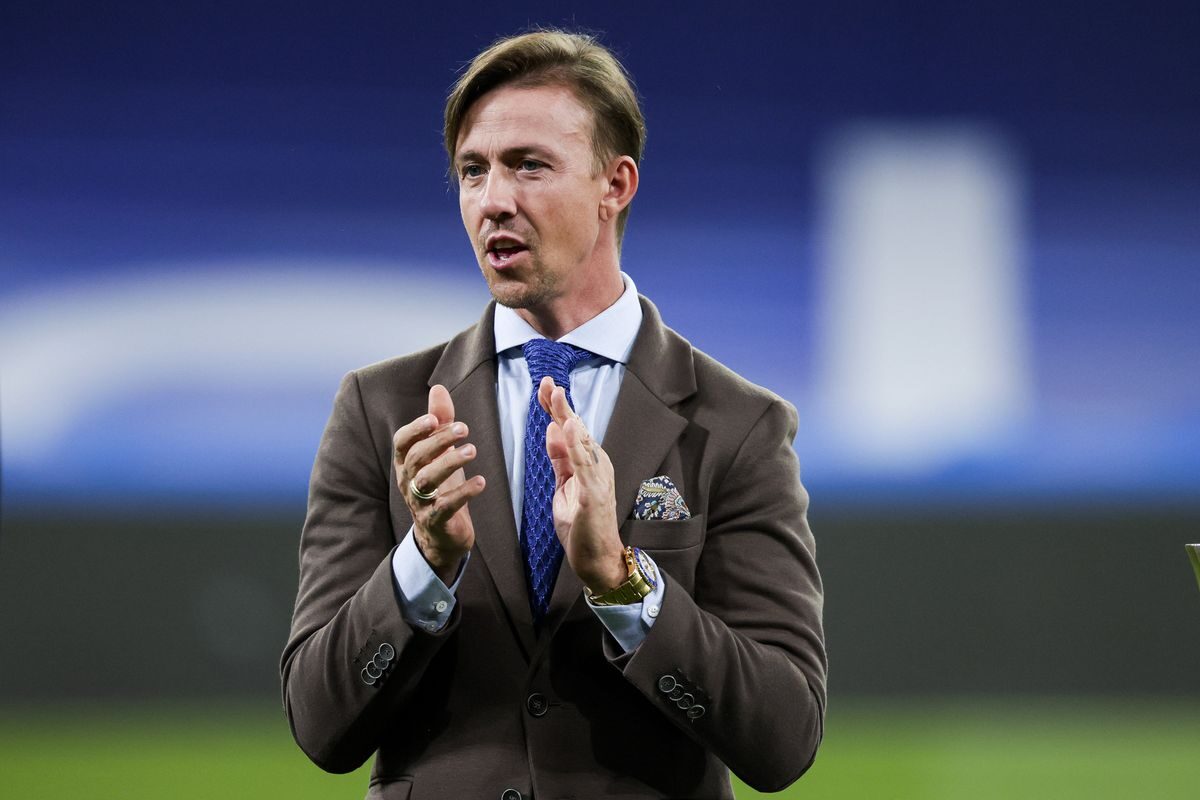 a man in a suit and tie clapping